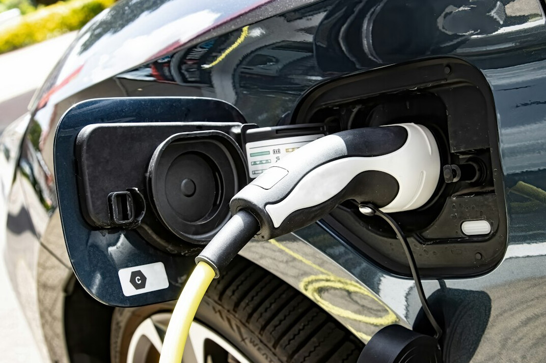 Electric car charging port with a plug